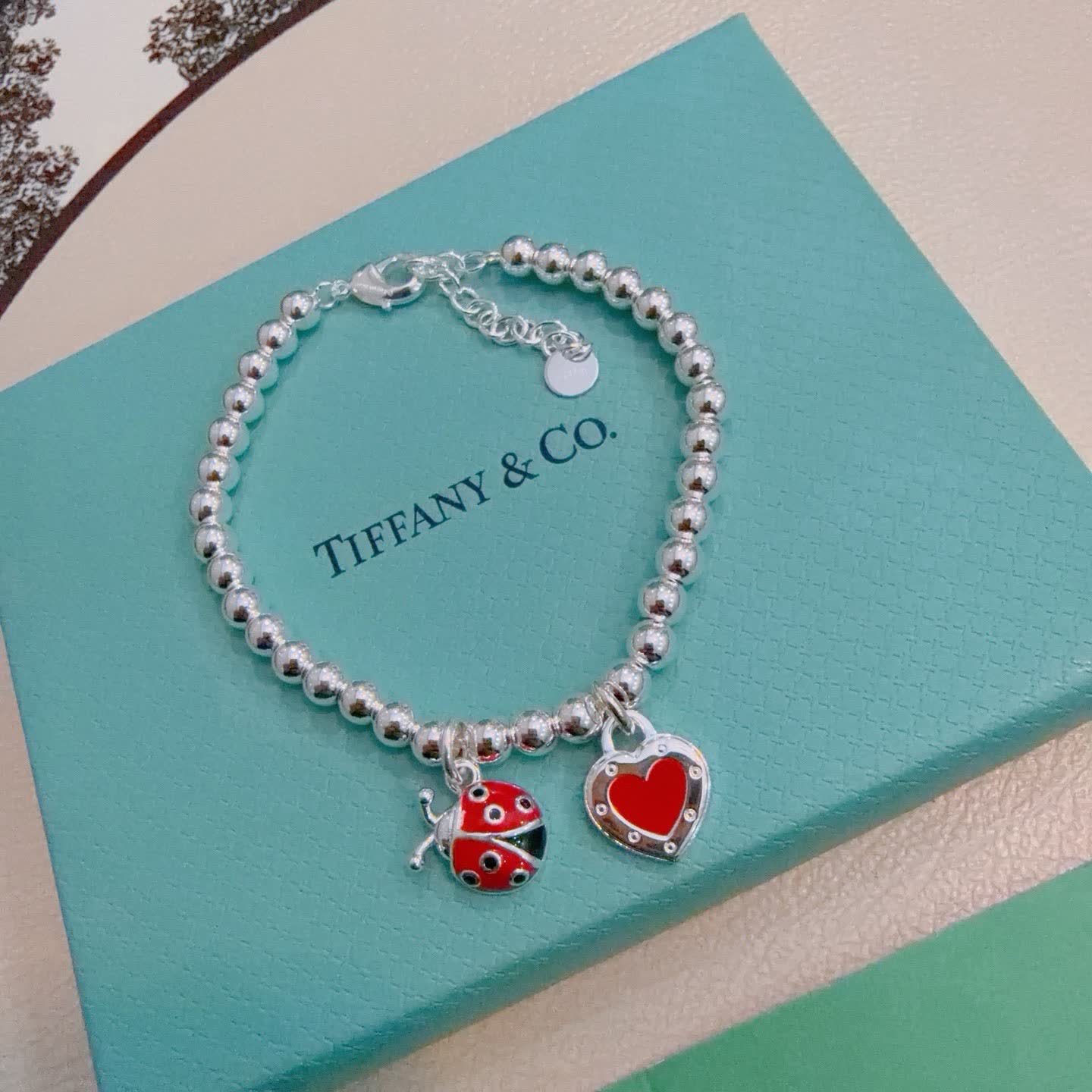 Tiffany & Co. Silver Bead Bracelet with Ladybug and Heart Charms